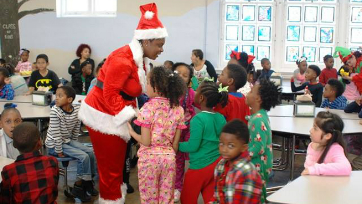 Dressed In Their Christmas Best, Second District Officers Dole Out Presents To More Than 200 Students